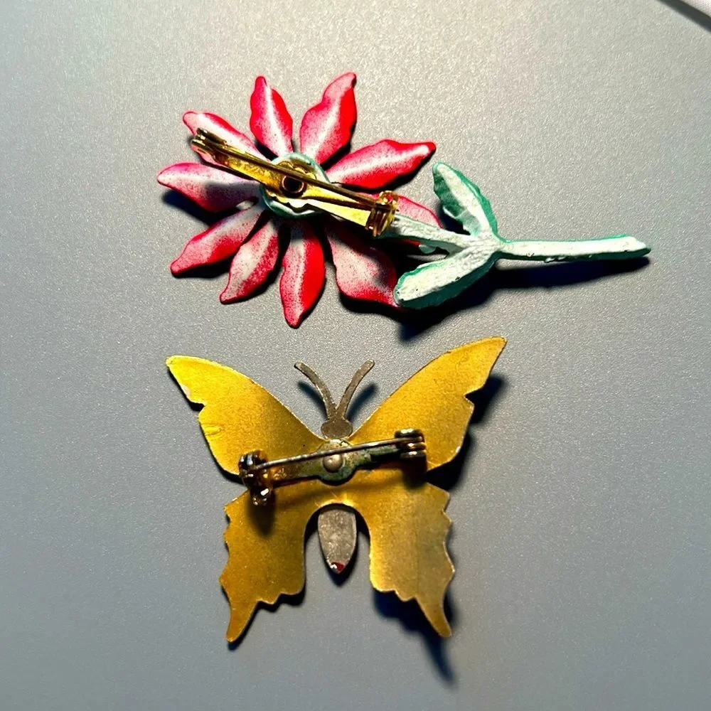Vintage pointsettia and butterfly enamel on metal brooch set